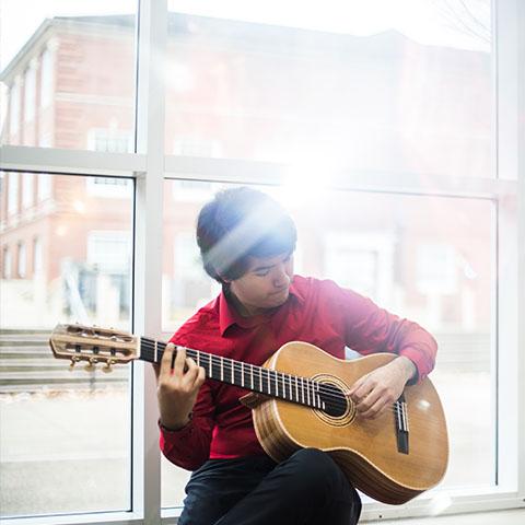 René Villareal plays guitar in Morgan University Center